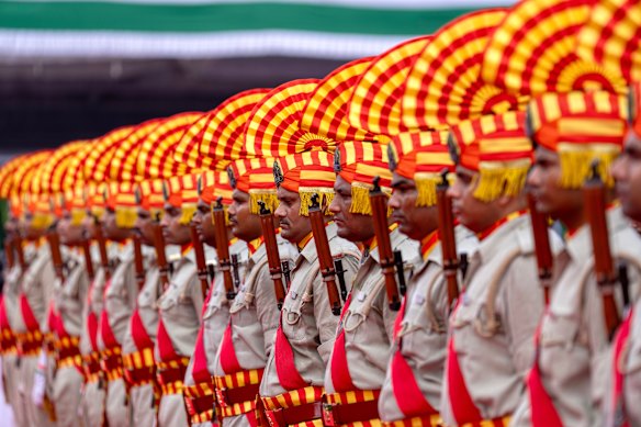 Police personnel stand in formation during Independence Day celebrations in Lucknow, India.