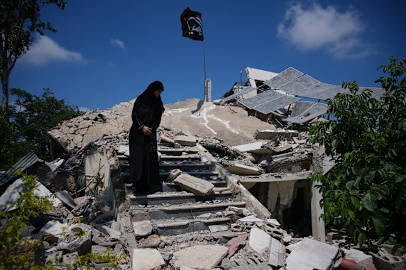 Fatima Mokdad stands amid the rubble of her home, which was destroyed in an Israeli airstrike during the Israel-Hezbollah war, where she and her family continue to live, using the only room that remained intact, in Froun village, southern Lebanon.