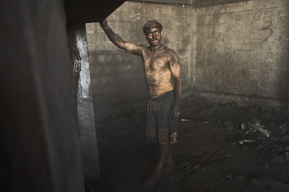 Diego Armando Custodio stands inside a coal sales market where he works in Buenos Aires, Argentina.