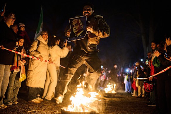 People attend a demonstration in support of the U.S. and Israeli strikes on Iran, in front of the Iranian embassy during the celebration of the Chaharshanbe Souri, or Wednesday Feast, an ancient Festival of Fire on the eve of the last Wednesday of the Persian year, in Berlin.