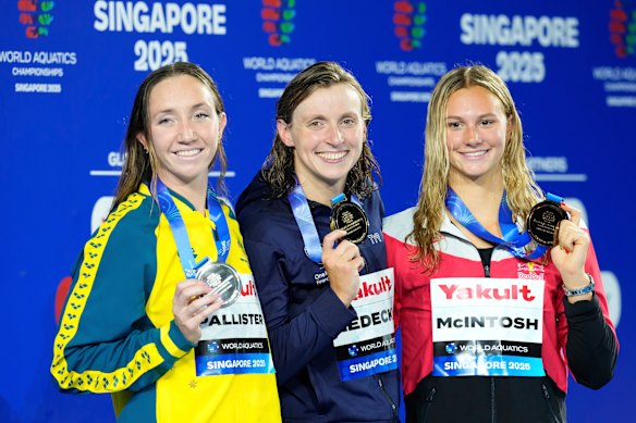 800m freestyle gold medallist Katie Ledecky of the United States, centre, flanked by silver medallist Lani Pallister of Australia, left, and bronze medallist Summer McIntosh of Canada, right. 