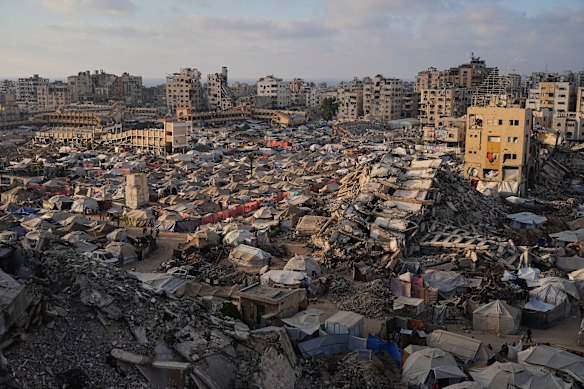 A tent camp for displaced Palestinians, pictured last week, stretches among the ruins of buildings destroyed by Israeli bombardments in Gaza City’s west.