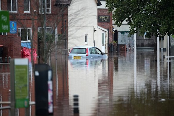 Cars are left partly submerged in floodwater in Monmouth.