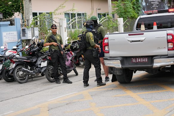 Police stand guard after the shooting.