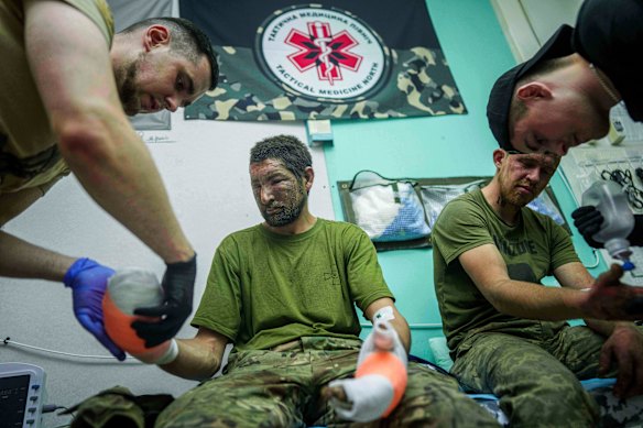 Ukrainian medics of Da Vinci Wolves Battalion treat their injured comrades near Pokrovsk on Sunday.