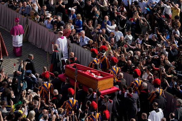 The procession accompanying the body of Pope Francis to St Peter’s Basilica passes through the crowd at the Vatican on Wednesday.