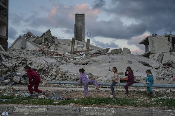 Girls play near destroyed buildings in the Zeitoun neighbourhood of Gaza City this week.