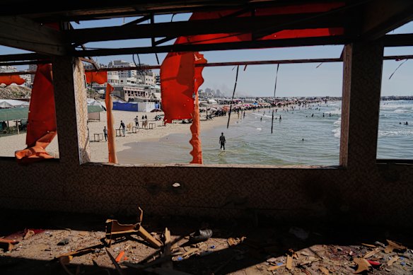 A Palestinian stands on the beach outside the cafe hit in Gaza City.