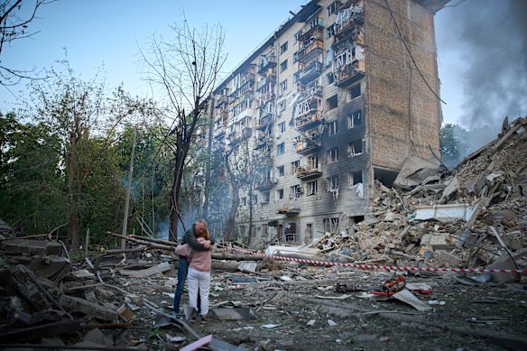 Residents embrace after a Russian missile hit an apartment building in Kyiv, Ukraine, last month.