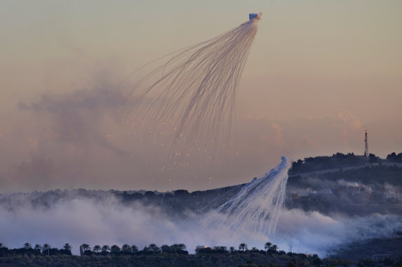 Shells that appear to be white phosphorus from Israeli artillery explode over Dahaira, a Lebanese border village with Israel, on October 16.