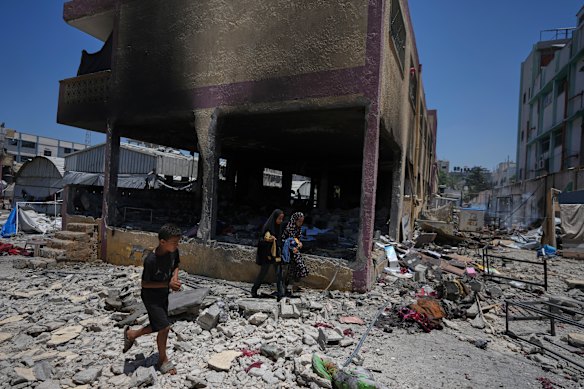 Palestinians survey the destruction at a school used as a shelter after it was struck by an Israeli airstrike in Gaza City.