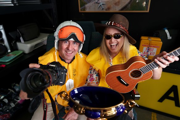 Brisbane Airport spokesman Peter Doherty (left) with some of the items up for auction at the 2025 Brisbane Airport auction.