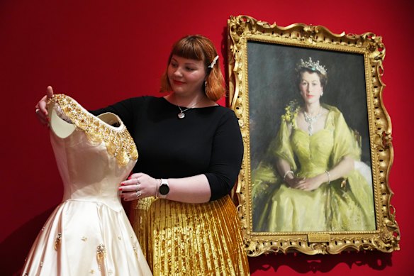 A curator at the Queen Elizabeth II: Her Life in Style exhibition.