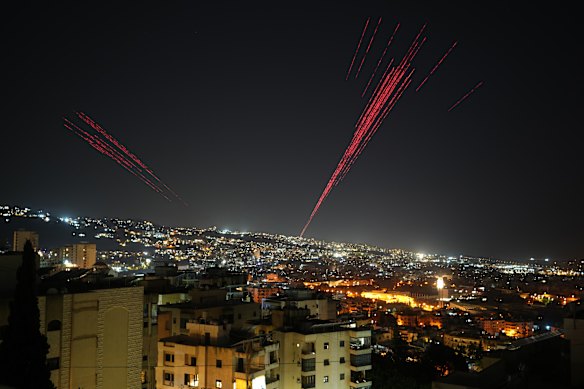 Tracer rounds illuminate the night sky as people fire live ammunition and fireworks into the air following a ceasefire between Israel and Hezbollah, in Beirut, Lebanon.