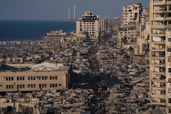 A makeshift tent camp for displaced Palestinians stretches across an area near the Gaza City port.