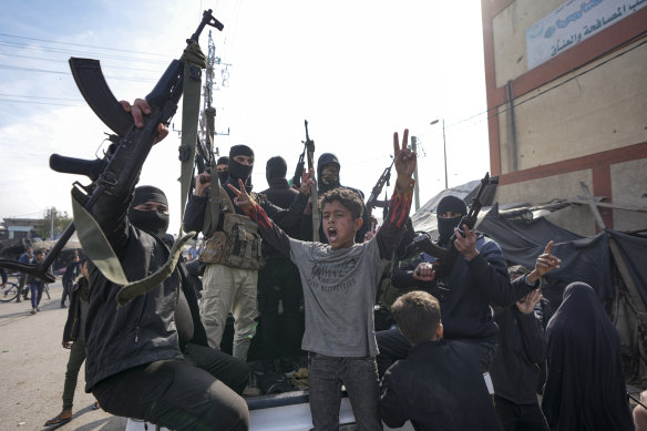Members of the Izzedine al-Qassam Brigades, the armed wing of Hamas, celebrate the ceasefire in Deir al-Balah.