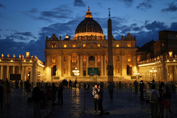 Journalists work at St Peter’s Square on Monday.