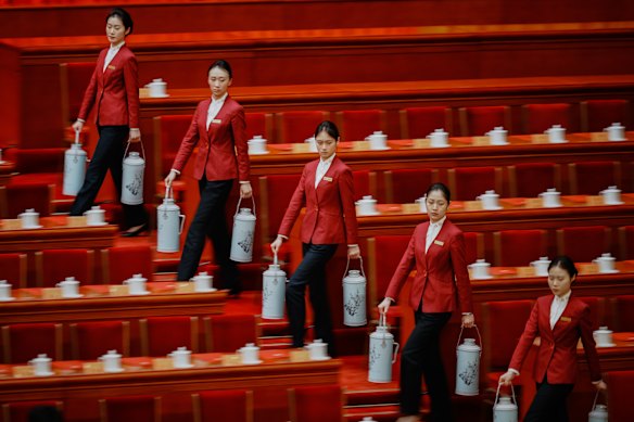 Hostesses prepare tea for delegates before the closing ceremony of the Chinese People’s Political Consultative Conference (CPPCC) at the Great Hall of the People in Beijing.