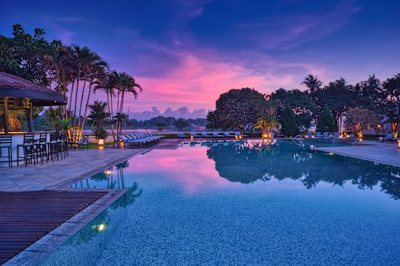 Pink skies while poolside at Azerai La Residence Hue.