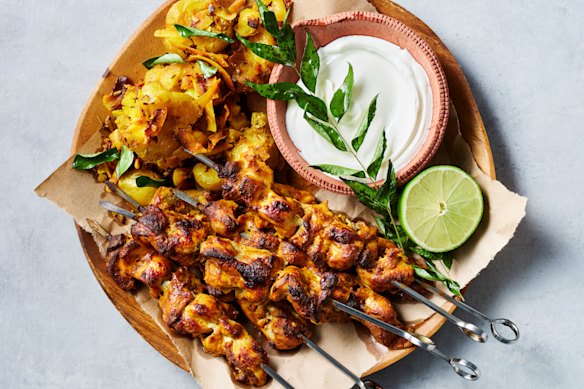 Tikka chicken skewers with crunchy coconut potatoes.