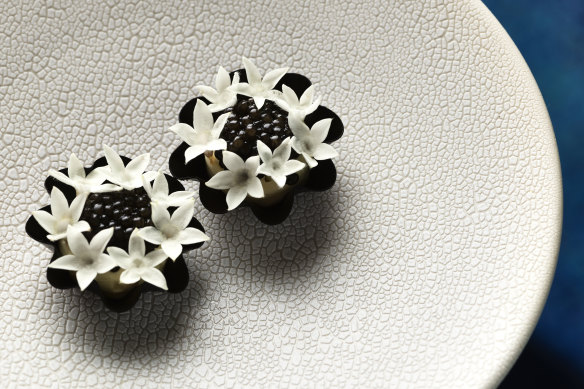 Amuse-bouche tarts filled with whipped creme fraiche and topped with oscietra caviar.