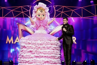 Osher Gunsberg with one of the many outrageously dressed performers from The Masked Singer.