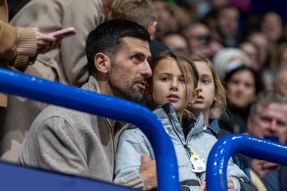 Novak Djokovic and his family watch the figure skating.
