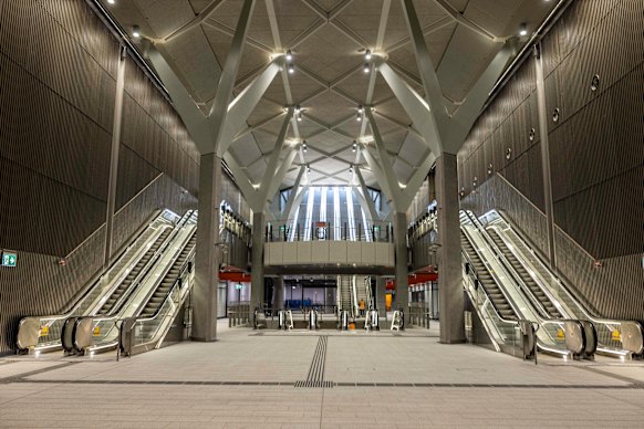 The entrance to Town Hall Station descends into a concrete box the architects have cheerfully christened “the crypt”.
