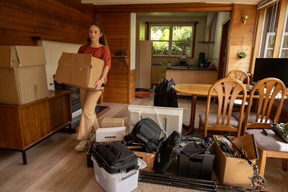 Actor Ellen Burbidge, pictured here packing to move between houses in Hobart, sought refuge in Tasmania after surviving the 2019 fires on the NSW south coast.