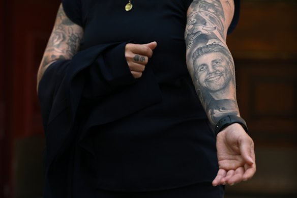 Natalie Gordon shows her brother’s face tattooed on her arm.