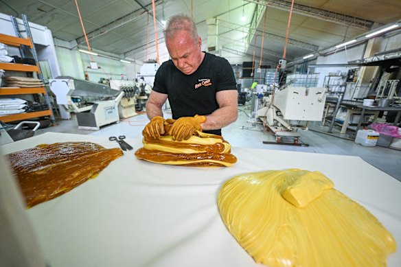 Steve Scott cuts and sticks together solidified portions of lolly solution to make a big mass.