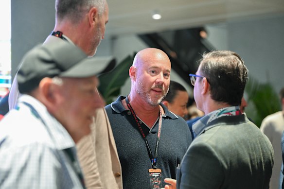 Luke Sayers (centre) at the Grand Prix on March 16. His firm has been renamed and has a new chairman.