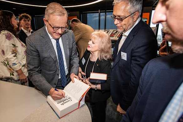 Anthony Albanese signing copies of Troy Bramston’s biography of Gough Whitlam at the launch.