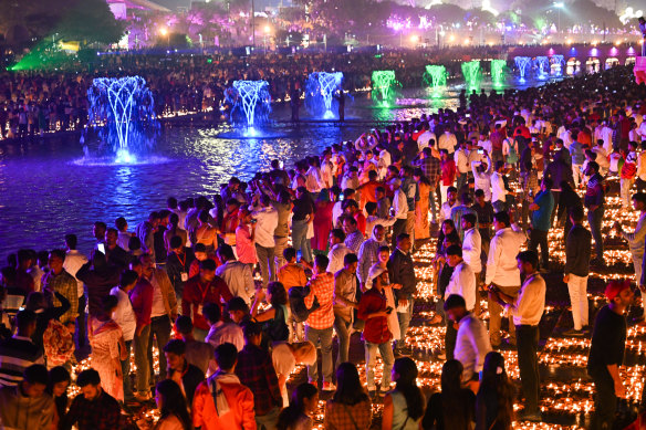 People light earthen lamps on the banks of Saryu River to mark Diwali.