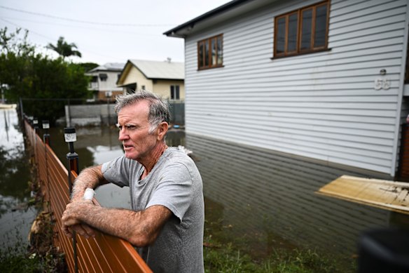 Merv Birt outside his soaked home in Tingalpa on Brisbane’s east side, the worst flood he’s lived through.