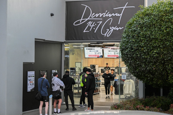People line up outside the 24/7 gym in Oakleigh East, pictured in August, with security hired to manage patron limits.