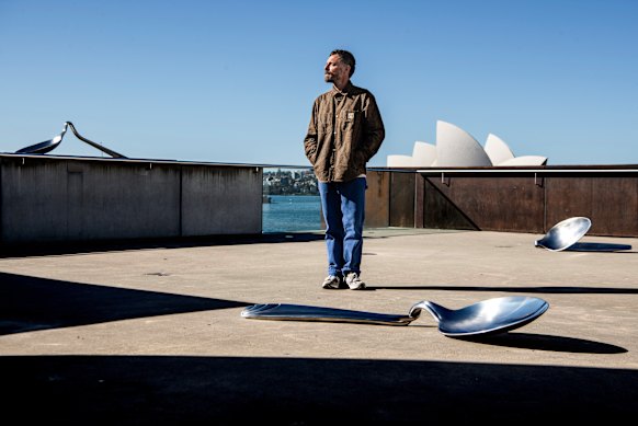 Ricky Swallow with his larger-than-life wax-printed teaspoons at the Museum of Contemporary Art. 