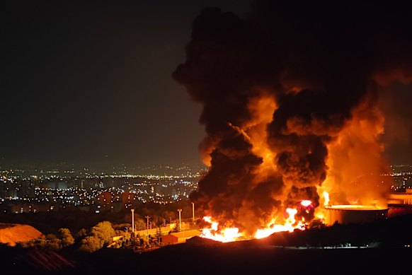 Fire and smoke rise into the sky after an Israeli attack on the Shahran oil depot in Tehran.