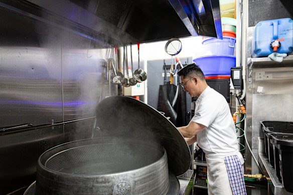 Michael Kim tending to the 240-litre, cast iron cauldron.