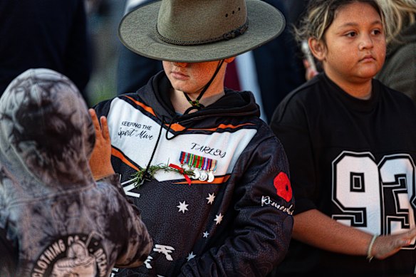 Young and old commemorate ANZAC day.
