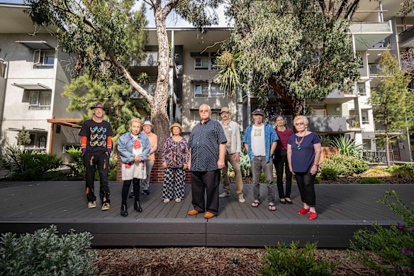 Community housing provider HousingFirst is selling off 25 social housing units at the Inkerman Oasis development to the private market. These properties were originally gifted to the Port Phillip Housing Trust in the early 2000s in exchange for a 1.223ha council depot site.
John Cocks (Centre) with fellow residents at Inkerman Oasis, 7 Greeves Street, St Kilda who all face relocation.