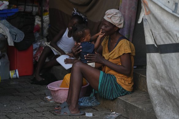 A woman holds her child at a shelter for families displaced by gang violence in Port-au-Prince, Haiti, Tuesday, Jan. 27, 2026.