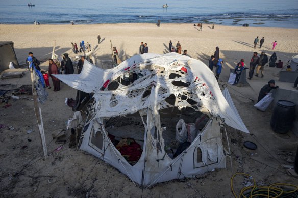 Palestinians inspect the site of an Israeli army strike early Tuesday morning in Deir Al-Balah in the central Gaza Strip.