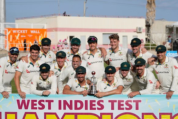 Australia players pose with the trophy after day three of their third Test cricket match against West Indies at Sabina Park in Kingston, Jamaica,