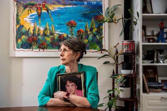 Coralie Wales with a picture of her mother, Bonnie Jean Tosswill, and a painting by the prolific artist. 