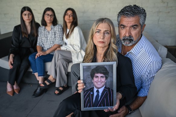 James Tsindos’ family (left to right) sisters Elpida (in black), Kristina, and Georgia (in white), mother Venetia (holding a picture of James) and father Harry Tsindos. Their 17-year-old son, James, died in 2021 after going to Holmesglen Private Hospital.