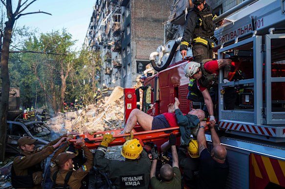 Rescue workers evacuate an injured man from a multi-storey residential building destroyed by a Russian strike in Kyiv, Ukraine, on Tuesday.