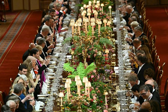 Guests raise their glasses for a toast.