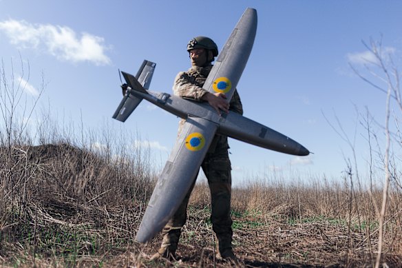 A soldier from the “Taifun” unmanned aerial vehicle unit holding a new model ‘Marsianin’ attack drone on April 7, 2026 in Kharkiv region, Ukraine. After years of developing systems and know-how to fend off Russia’s drone attacks, Ukraine is now offering its hard-won expertise and counter-drone technology to other countries. 