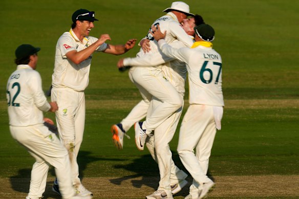Matt Renshaw celebrates with teammates after taking a wicket on day four of the Test.